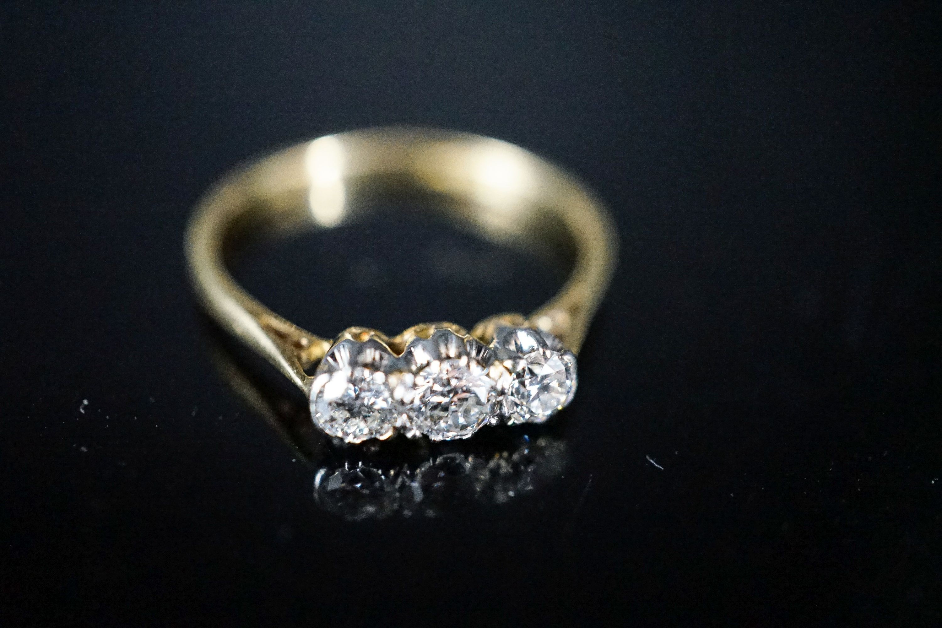 An 18ct & plat, three stone diamond ring, size O, gross 2 grams.